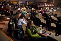 Group of seated attendees focusing on a presentation