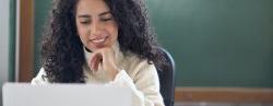 Young woman school teacher working on laptop